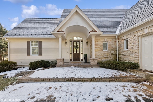 view of snow covered property entrance