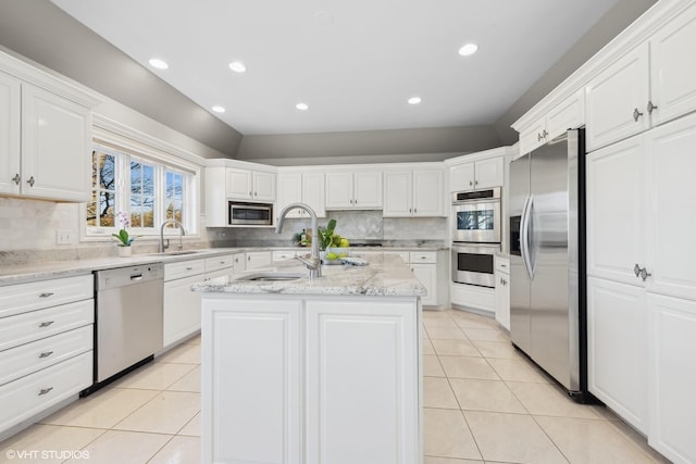 kitchen featuring stainless steel appliances, an island with sink, and white cabinets