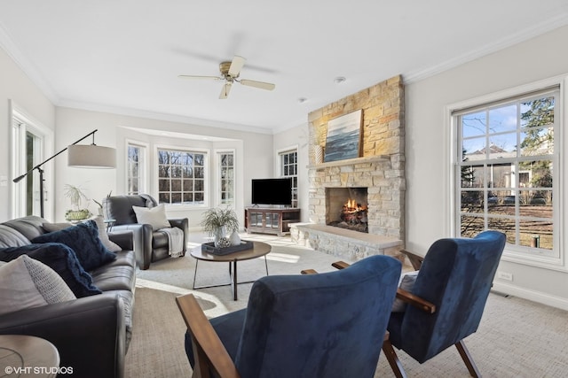 living room with carpet flooring, ornamental molding, a stone fireplace, and a wealth of natural light