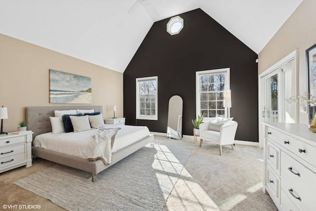 bedroom featuring light carpet, high vaulted ceiling, and ceiling fan