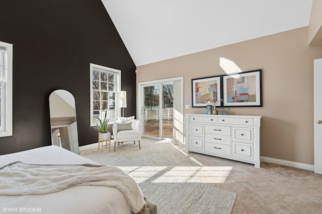 carpeted bedroom with access to outside and high vaulted ceiling