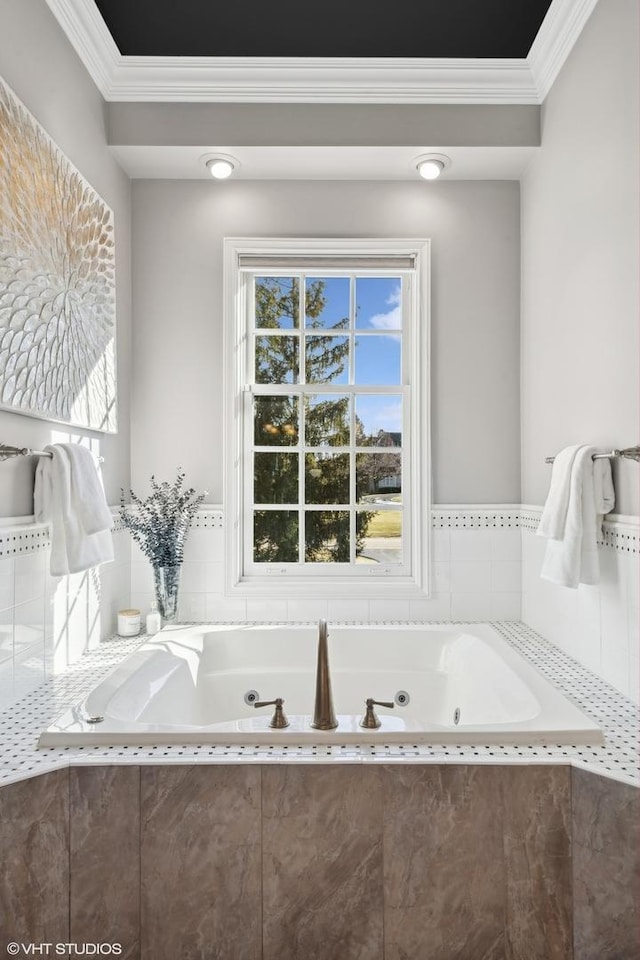 bathroom featuring crown molding and tiled bath