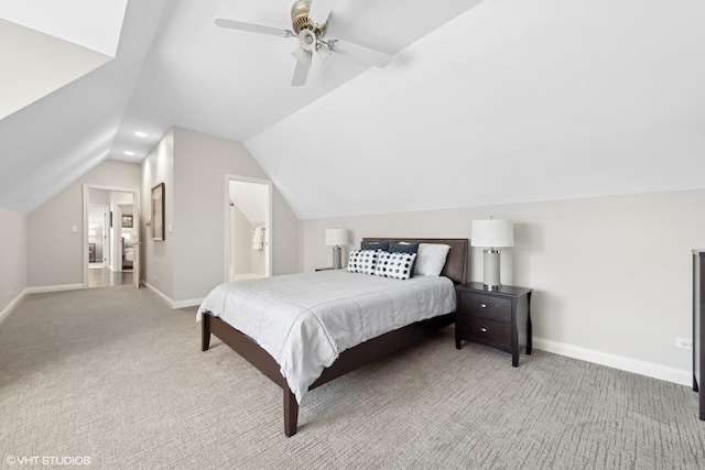 carpeted bedroom with lofted ceiling, connected bathroom, and ceiling fan