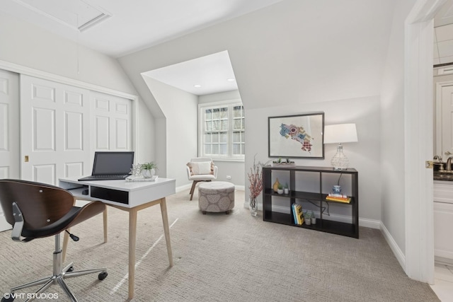 home office featuring vaulted ceiling and light colored carpet