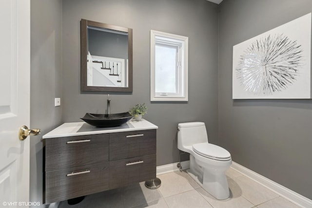 bathroom featuring tile patterned flooring, vanity, and toilet