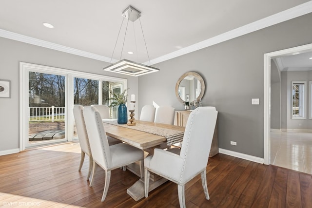 dining area with ornamental molding, a healthy amount of sunlight, and hardwood / wood-style floors