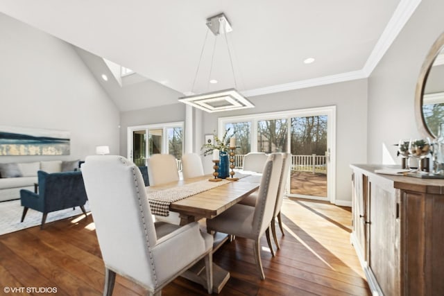 dining area with crown molding, lofted ceiling, and dark hardwood / wood-style flooring