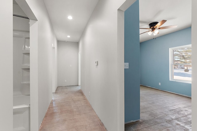 corridor featuring light wood-style floors and recessed lighting