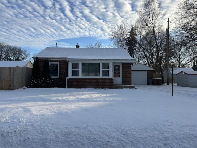 view of front of house featuring a storage shed and a garage