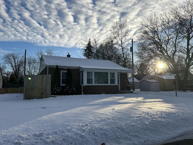 view of front facade featuring a storage shed