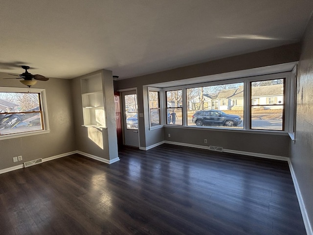 spare room featuring ceiling fan and dark hardwood / wood-style floors