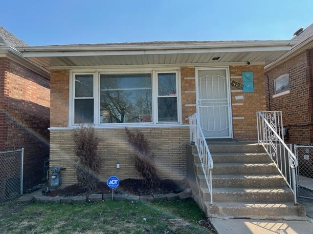 425 E 91st St, Chicago, IL 60619 - doorway to property featuring brick siding and fence