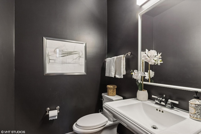 bathroom featuring sink and toilet