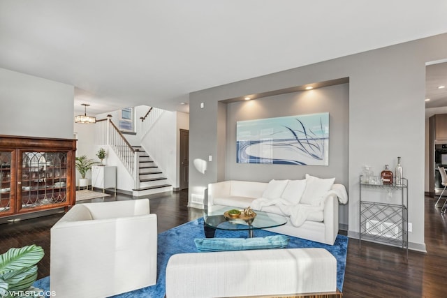 living room featuring a notable chandelier and dark hardwood / wood-style floors