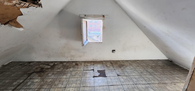 additional living space featuring lofted ceiling