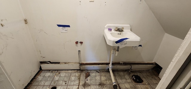 clothes washing area with sink