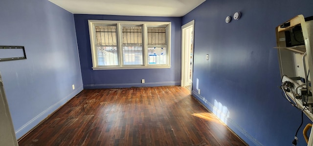 empty room featuring dark wood-type flooring