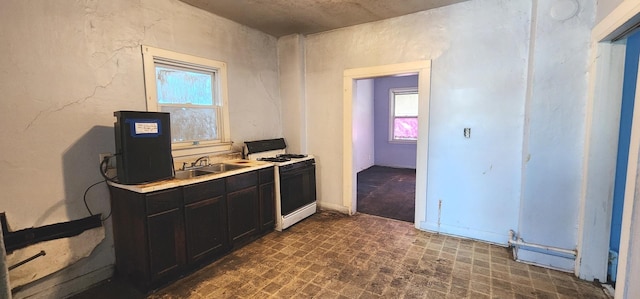 kitchen with white range with gas stovetop and sink