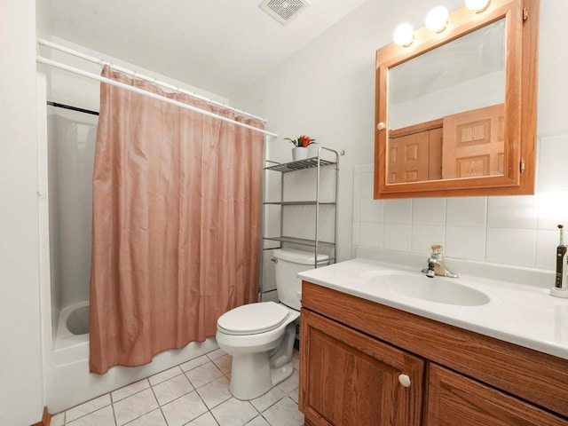 bathroom featuring toilet, tile patterned floors, vanity, visible vents, and shower / tub combo with curtain