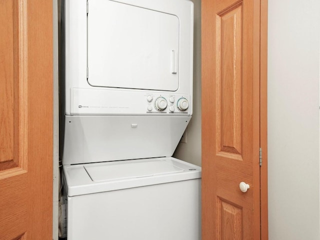 laundry room with stacked washer / drying machine and laundry area