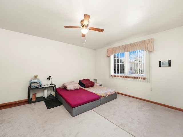 carpeted bedroom featuring a ceiling fan and baseboards