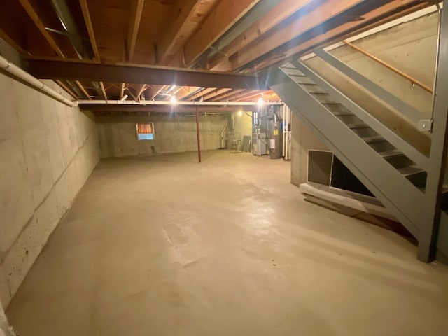 unfinished below grade area featuring water heater