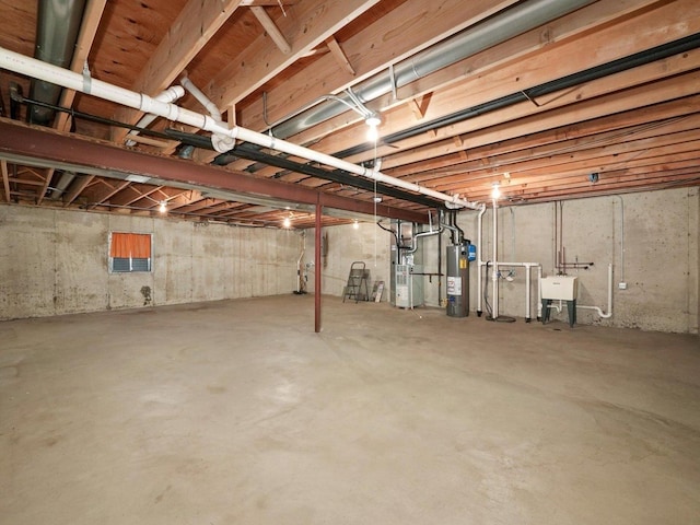 unfinished basement with gas water heater and a sink