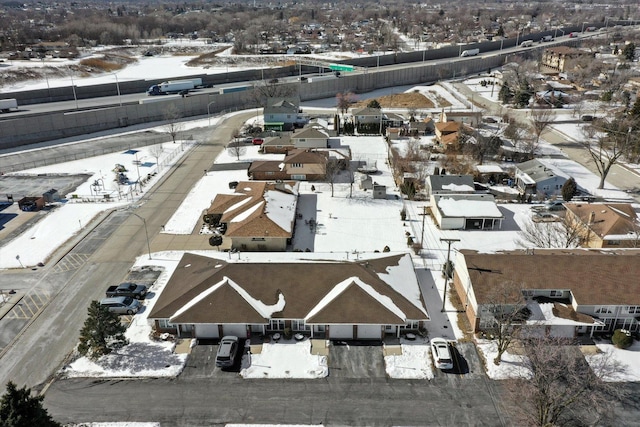 snowy aerial view with a residential view