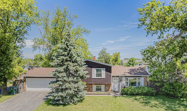 tri-level home with a garage and a front lawn