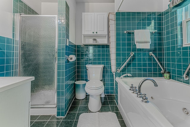 bathroom with toilet, tile walls, tile patterned floors, and separate shower and tub