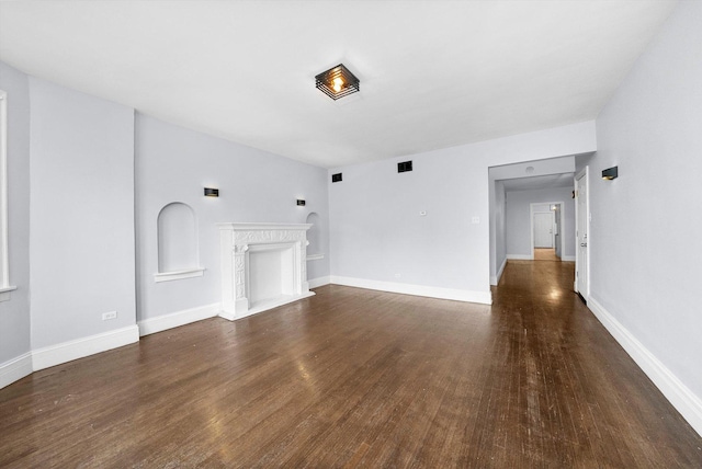 unfurnished living room with dark wood-type flooring