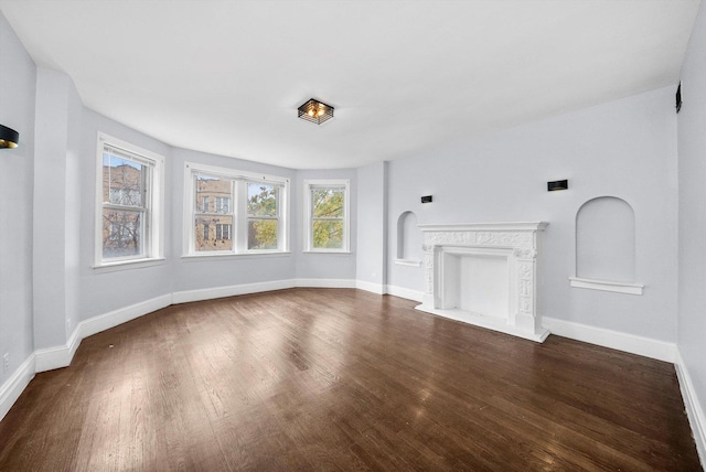 unfurnished living room featuring dark wood-type flooring