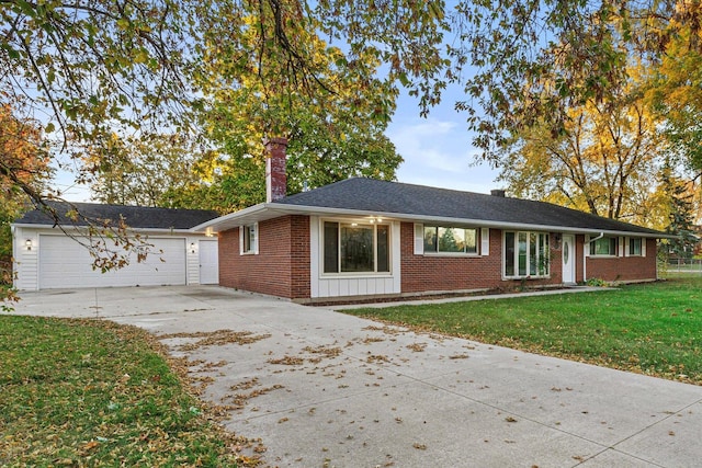 single story home featuring a front yard and a garage