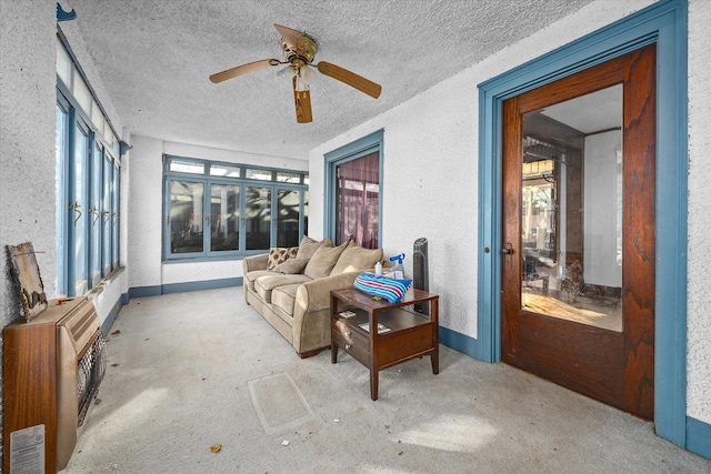 sunroom / solarium featuring ceiling fan