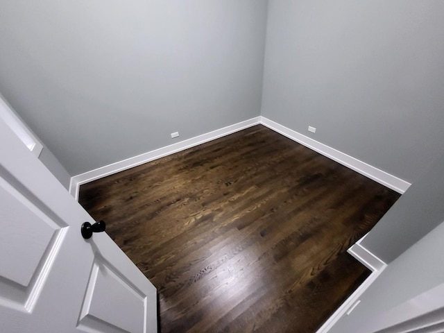 unfurnished room with wood finished floors and baseboards