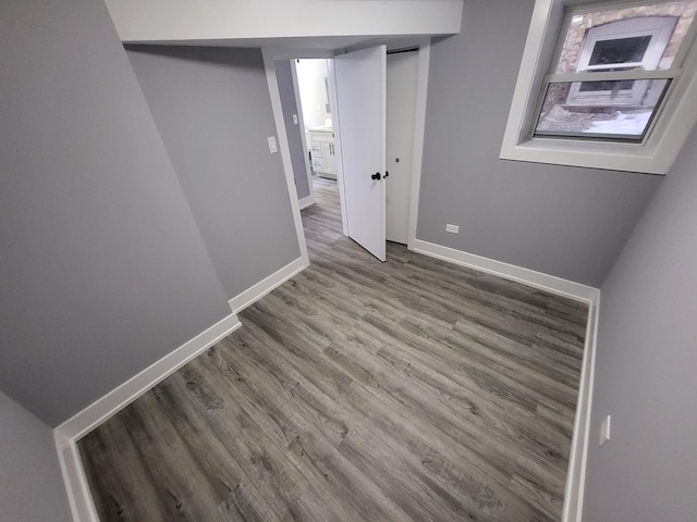 empty room featuring wood finished floors and baseboards