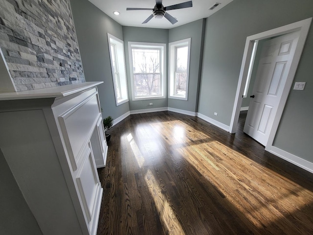 unfurnished living room featuring dark wood finished floors, recessed lighting, visible vents, a ceiling fan, and baseboards