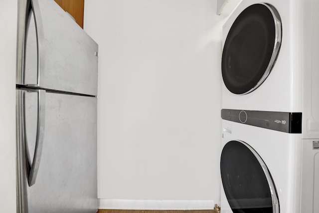 laundry room with stacked washer / dryer