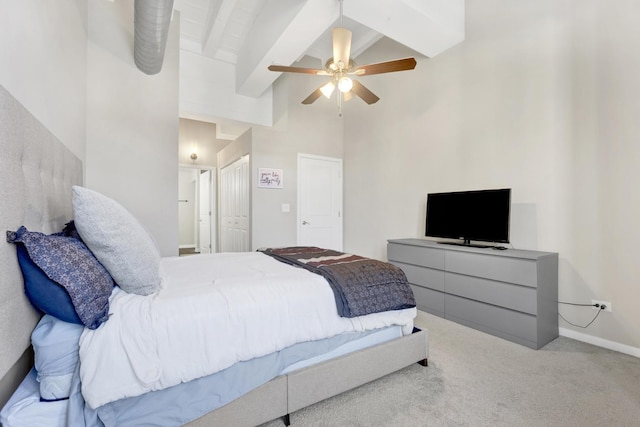 carpeted bedroom with ceiling fan, a towering ceiling, and beamed ceiling