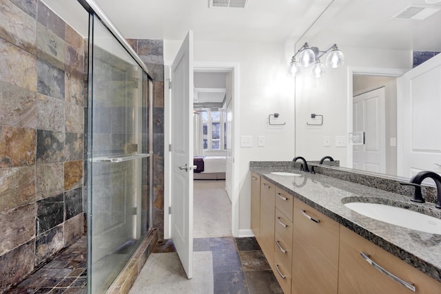 bathroom with walk in shower and vanity