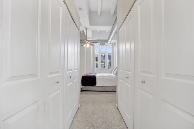 hall featuring light carpet and beamed ceiling