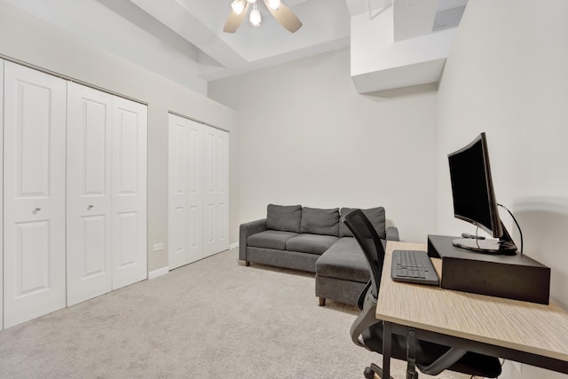 carpeted home office with ceiling fan