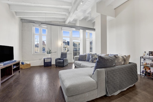 living room with dark wood-type flooring and vaulted ceiling with beams