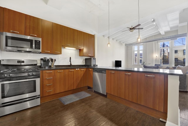 kitchen featuring vaulted ceiling with beams, sink, hanging light fixtures, appliances with stainless steel finishes, and dark hardwood / wood-style flooring