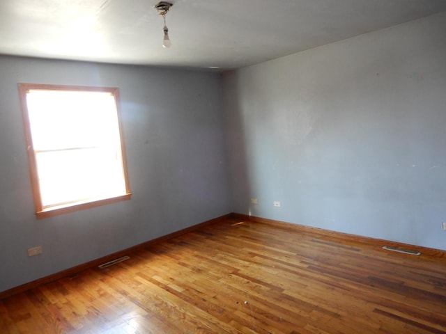 spare room with wood-type flooring