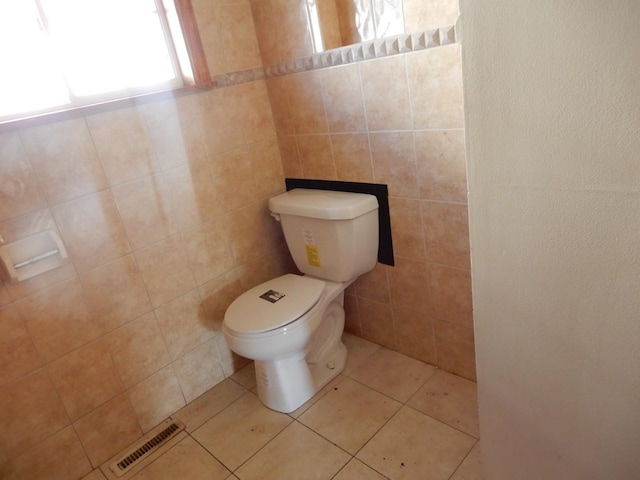 bathroom with toilet and tile patterned flooring