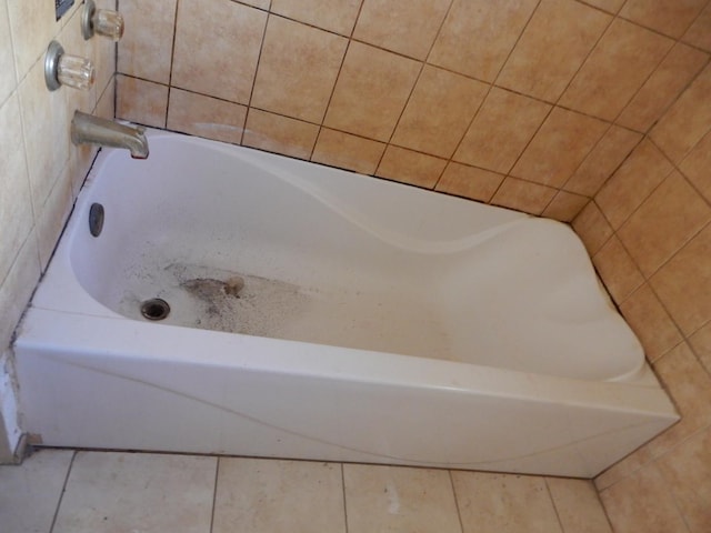 bathroom featuring tile patterned flooring and a bathing tub