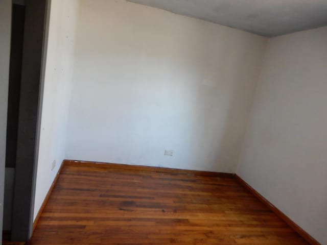 unfurnished room featuring dark hardwood / wood-style floors