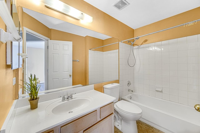 full bathroom featuring toilet, tiled shower / bath combo, and vanity