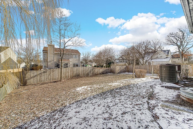 yard layered in snow with central AC unit